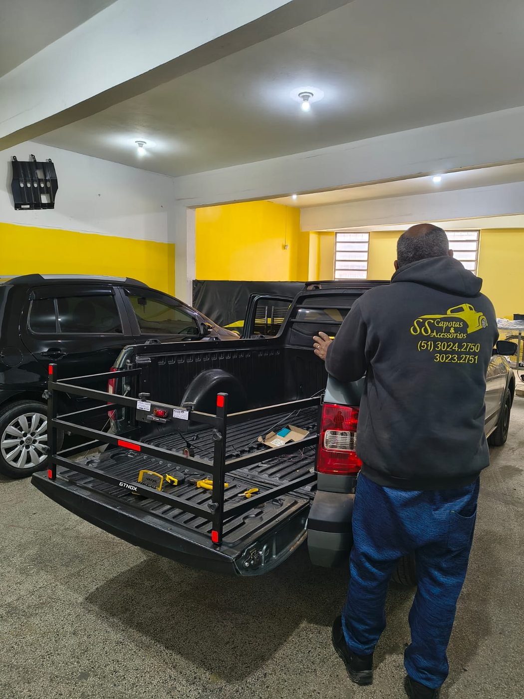 Equipe da SS Capotas instalando extensor de caçamba e divisor de carga em caminhonete
